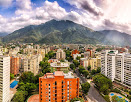 view of the city with mountains in background in caracas venezuela.